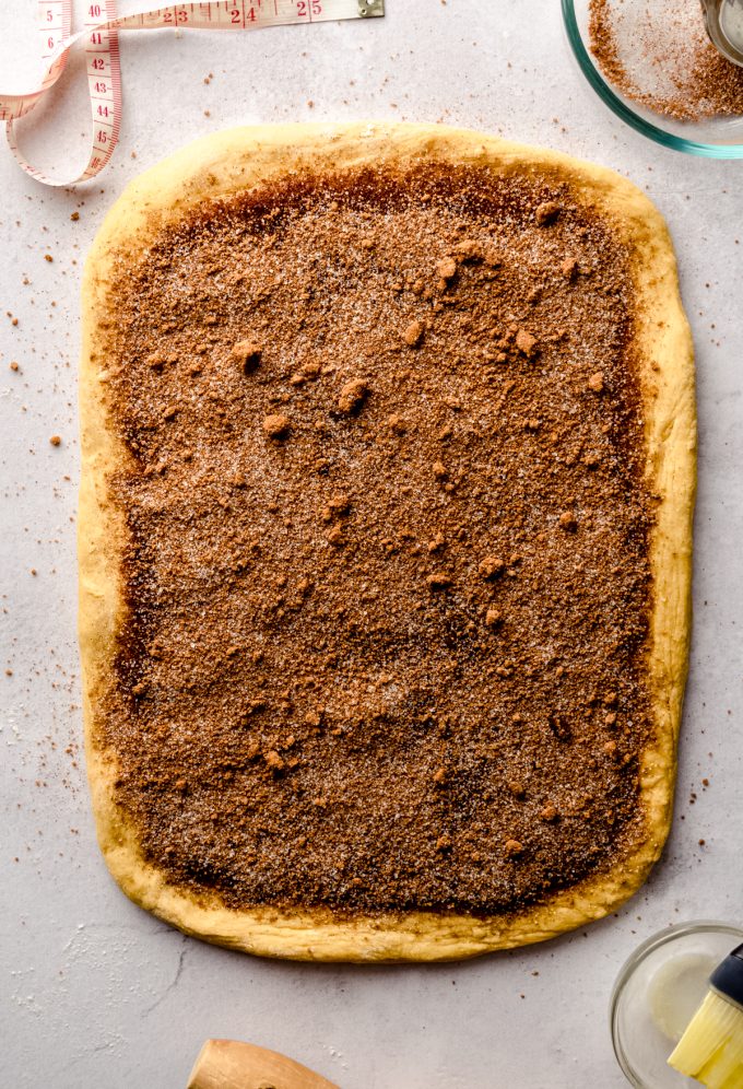 Aerial photo of a rectangle of dough to make pumpkin cinnamon rolls.