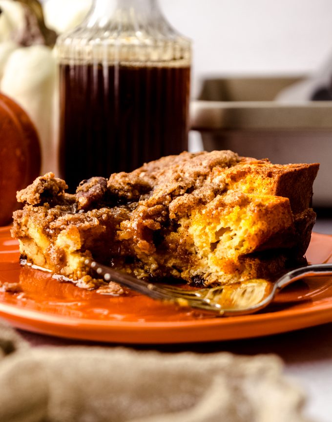 A slice of pumpkin French toast casserole on a plate with a fork.