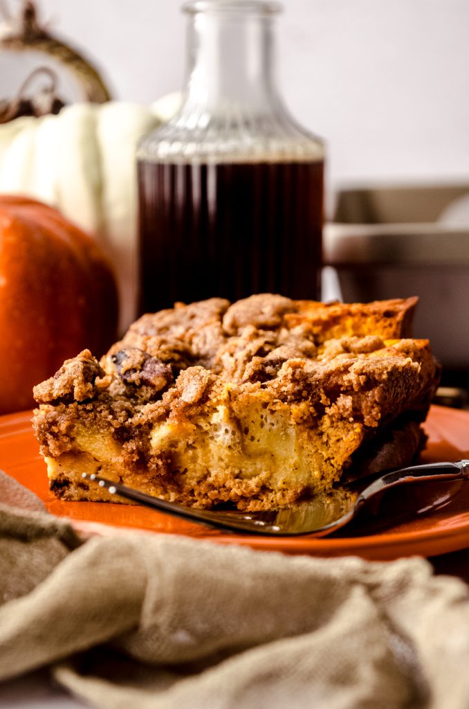 A slice of pumpkin French toast casserole on a plate with a fork.