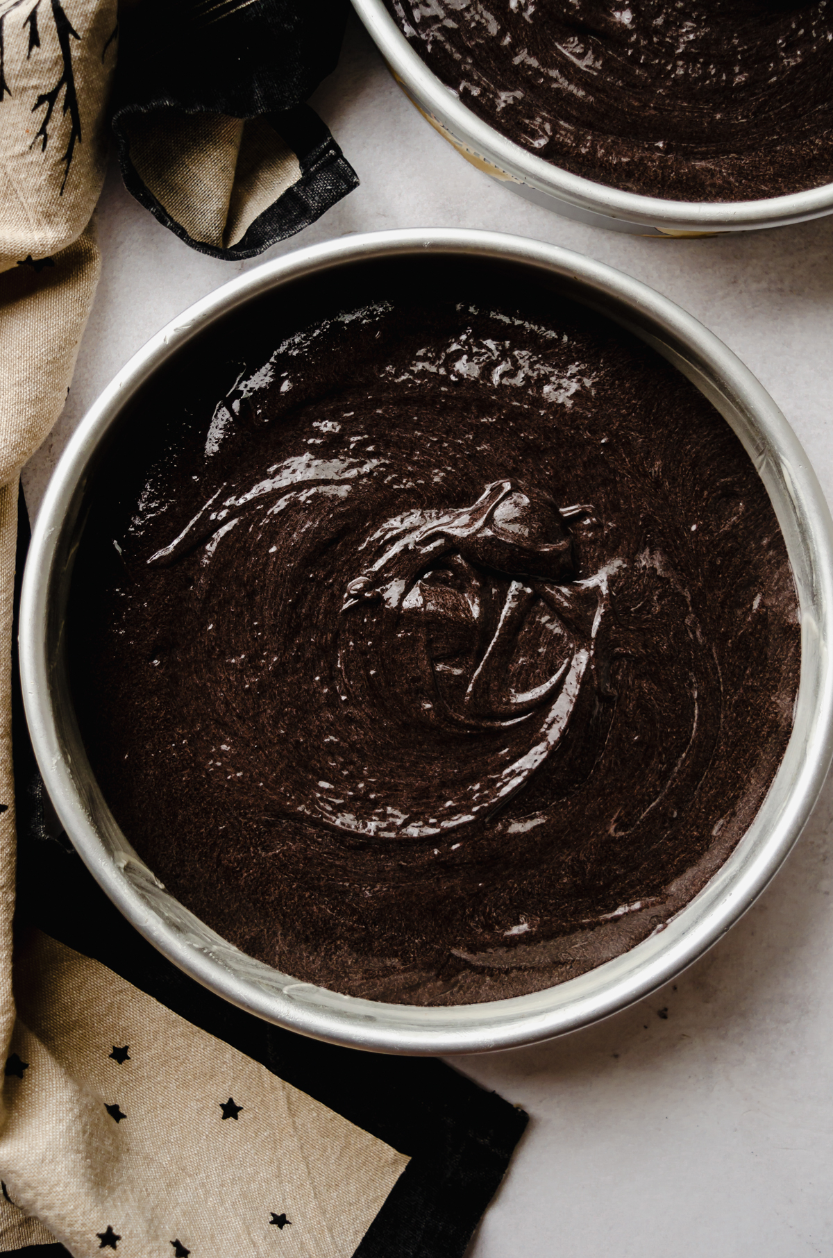 Aerial photo of chocolate Halloween cake batter in a cake pan.