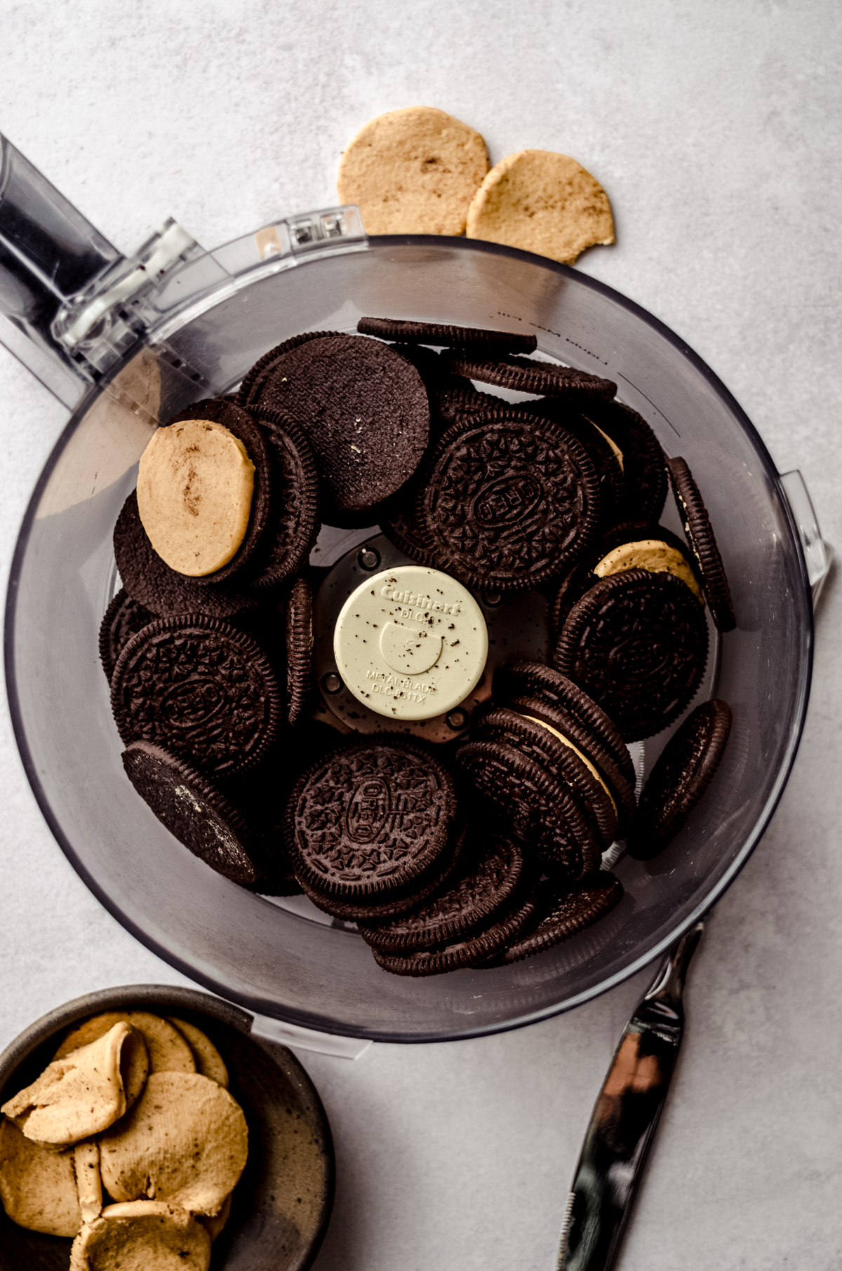 Aerial photo of the drum of a food processor with peanut butter Oreos in it.