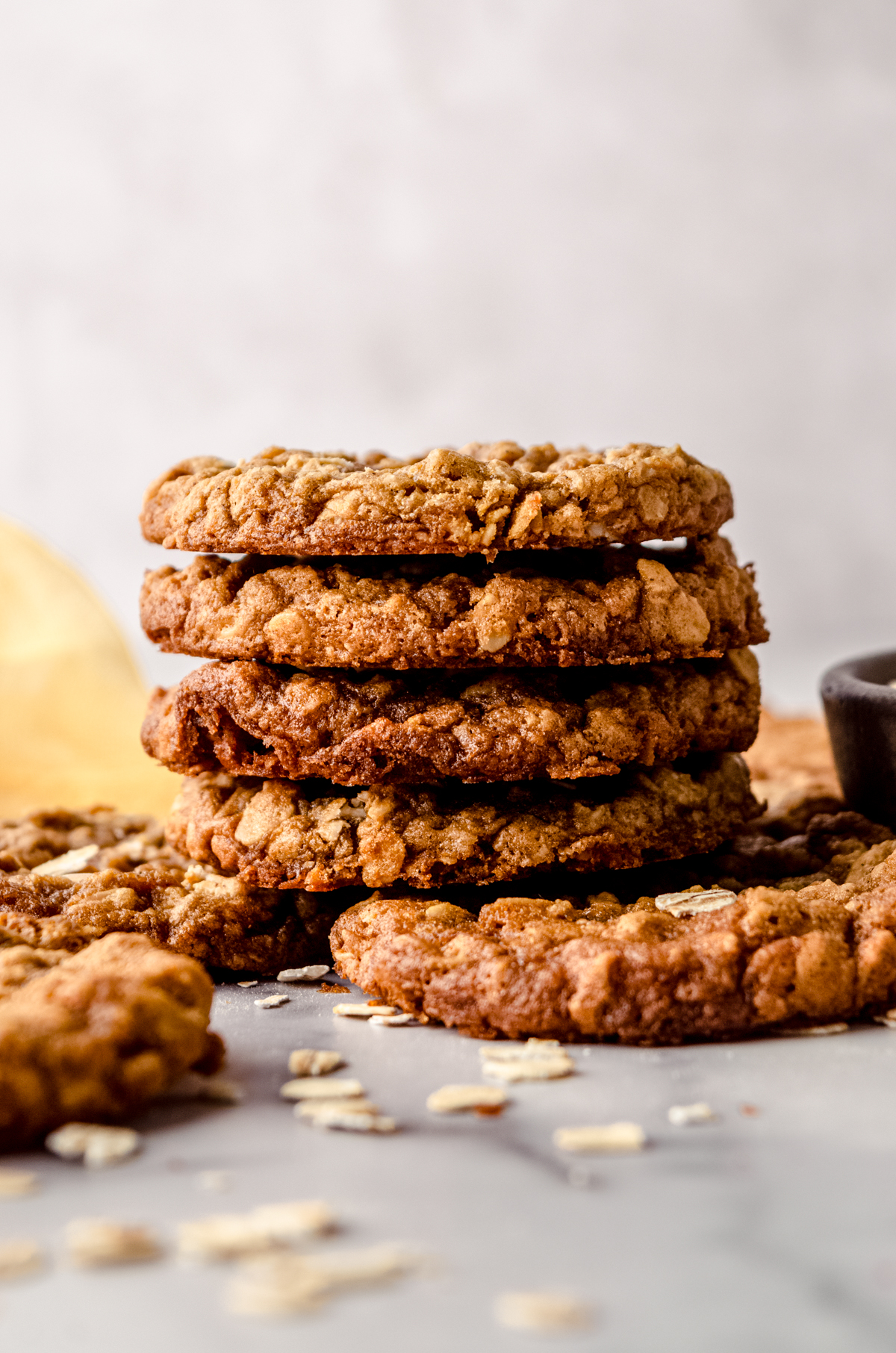 A stack of oatmeal cookies on a surface.