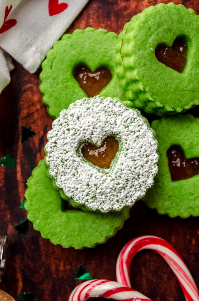 Aerial photo of Grinch Linzer cookies on a surface.