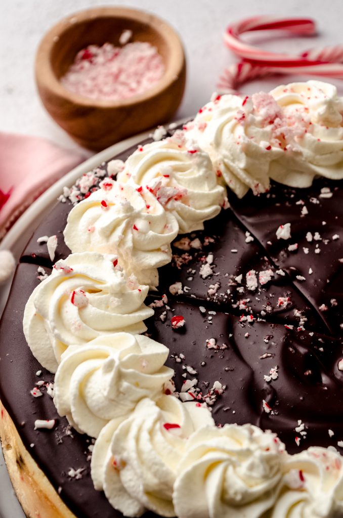 A peppermint bark cheesecake on a plate.