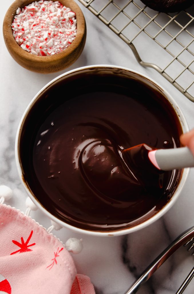 Aerial photo of a saucepan of chocolate ganache with a spatula in it.