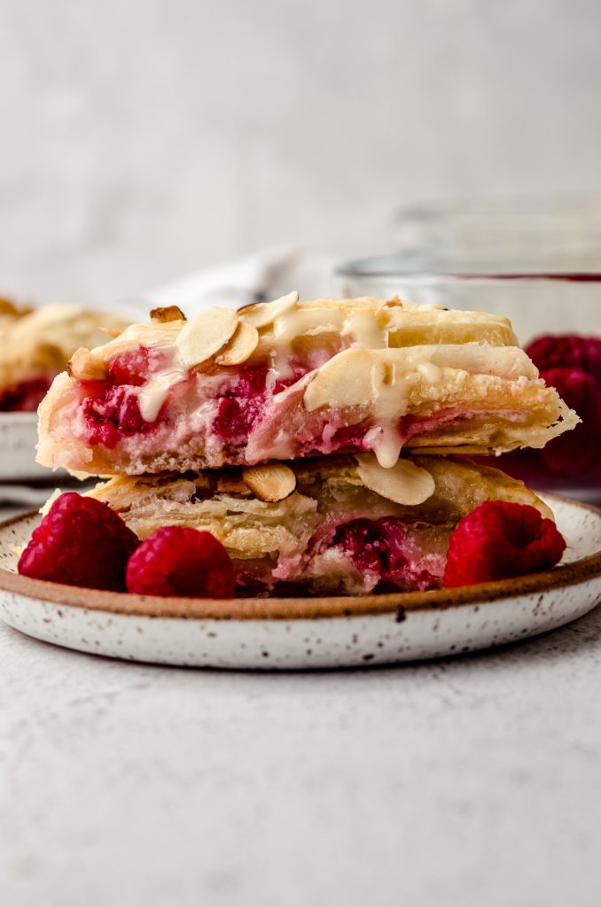 Slices of raspberry almond pastry stacked on a plate.