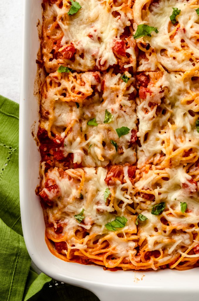 Aerial photo of a casserole of baked spaghetti that has been sliced.