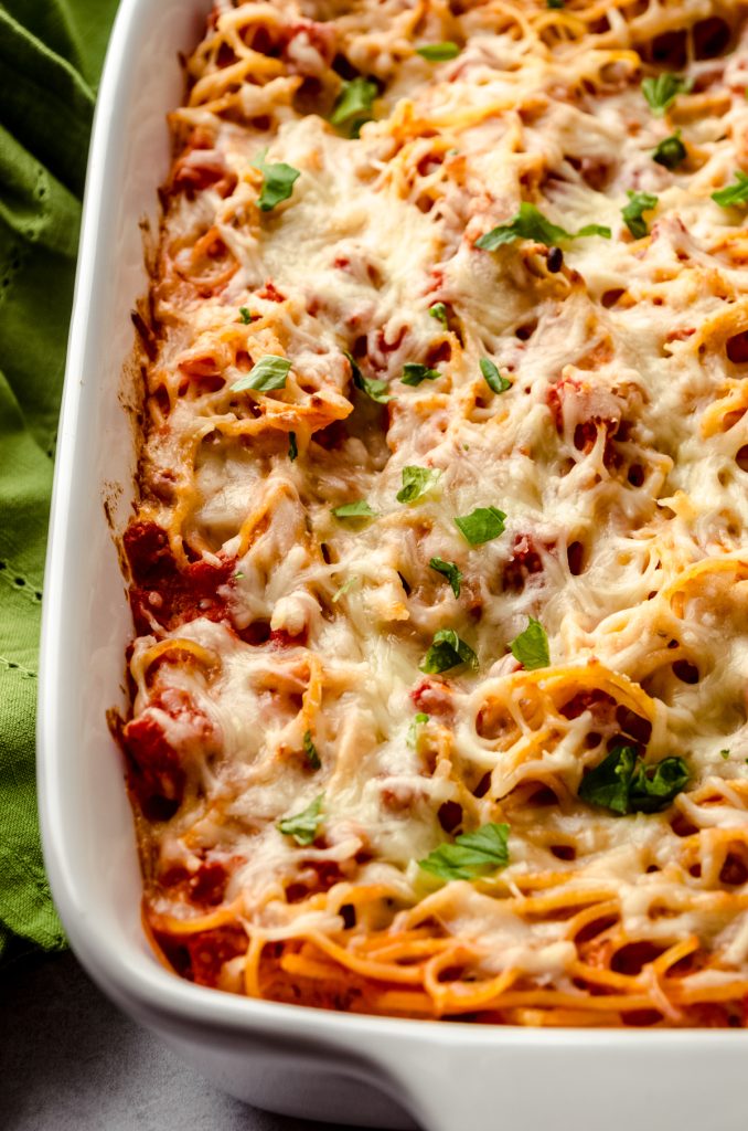 A closeup shot of a casserole of baked spaghetti.