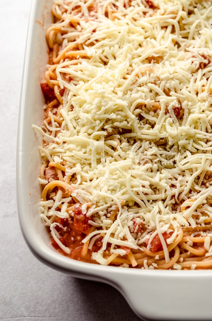 A closeup shot of a casserole of unbaked spaghetti.