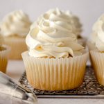 Vanilla cupcakes with a swirl of Swiss meringue buttercream piped on top.