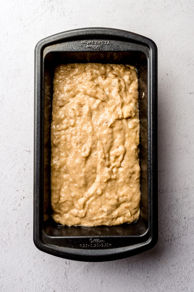 Aerial photo of banana bread batter in a loaf pan.