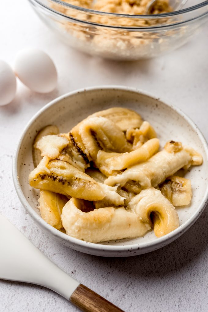 Roasted bananas in a white bowl.