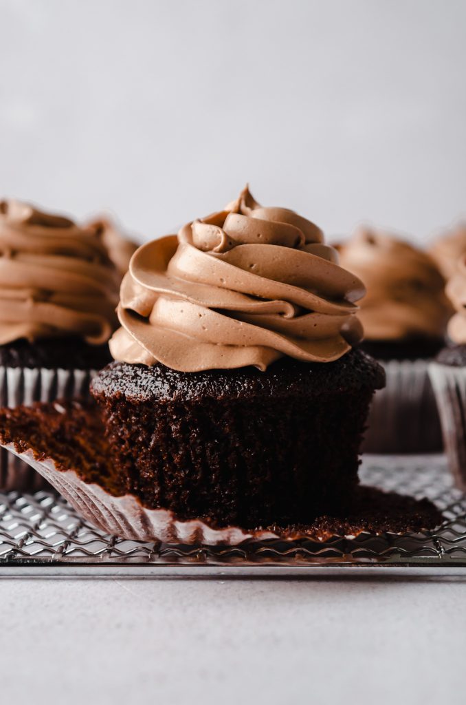 A chocolate cupcake with the wrapper pulled down.