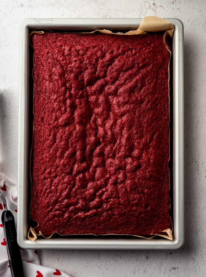 Aerial photo of a red velvet sheet cake in a baking pan.