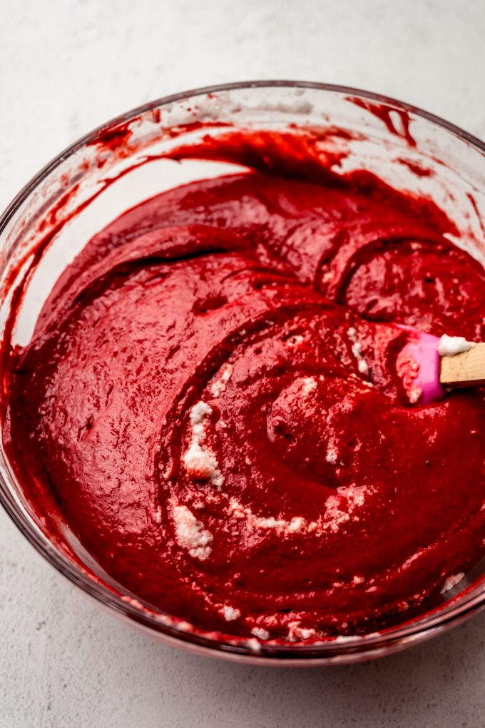 A bowl of red velvet sheet cake batter after whipped egg whites have been incorporated into it.