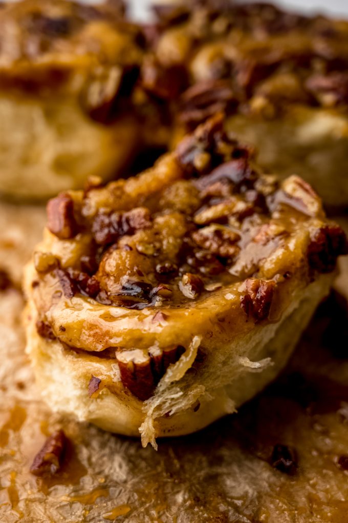 A sticky bun on a sheet of parchment paper.