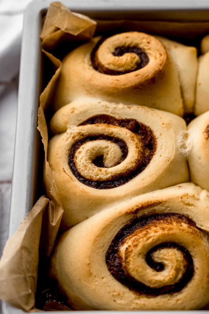 Baked sticky buns in a pan before being turned out onto a surface.