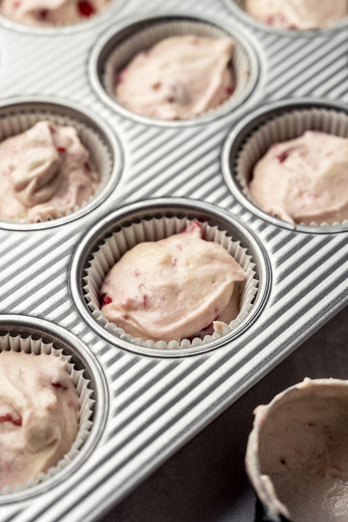 Strawberry cupcake batter portioned into a cupcake pan.