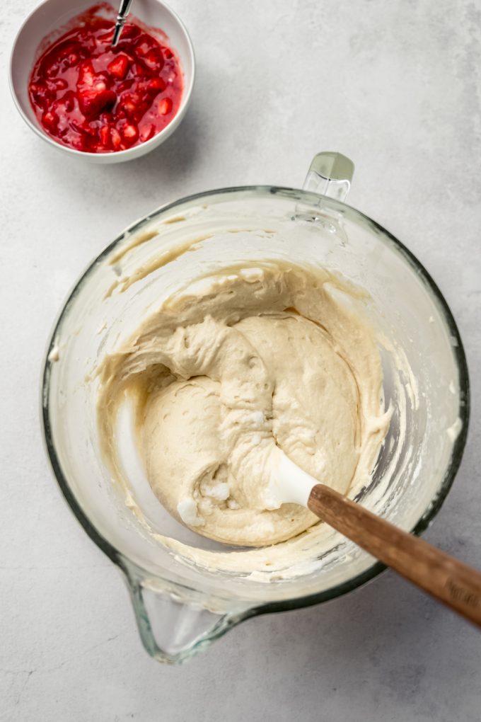 Aerial photo of strawberry cupcake batter with egg whites folded into it.