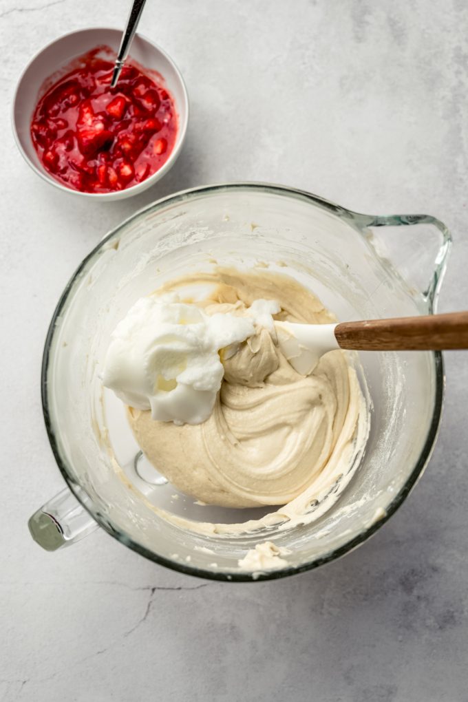 Aerial photo of strawberry cupcake batter with egg whites in it ready to be folded in.