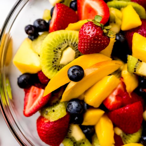 Aerial photo of fruit salad in a large glass bowl.