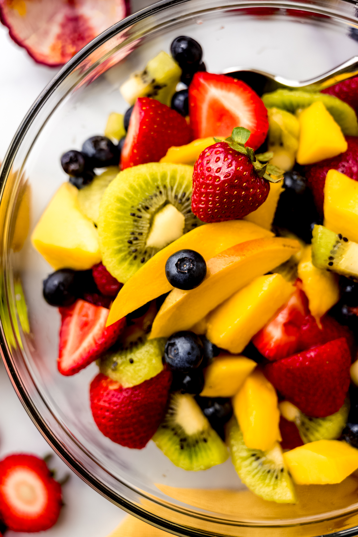 Aerial photo of fruit salad in a large glass bowl.