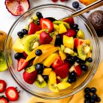 Aerial photo of fruit salad in a large glass bowl.