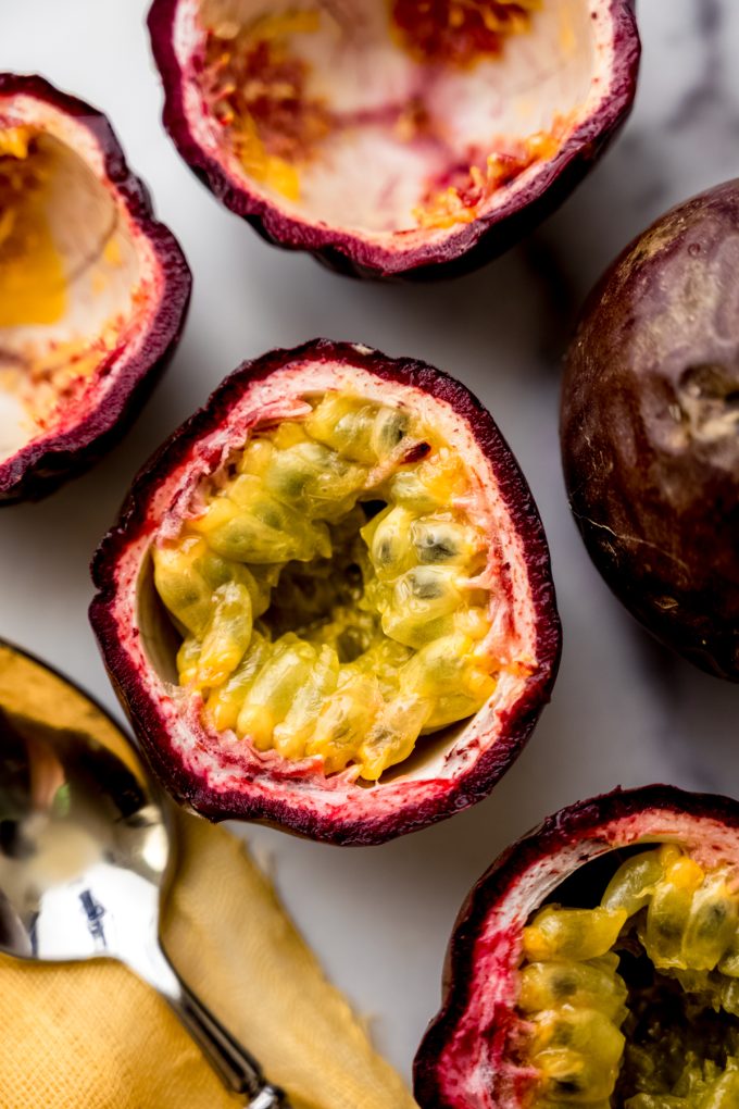 Aerial photo of a halved passion fruit on a surface.