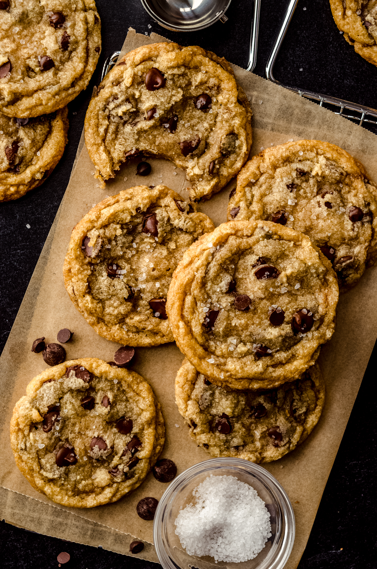 Aerial photo of brown butter chocolate chip cookies on a piece of parchment paper.