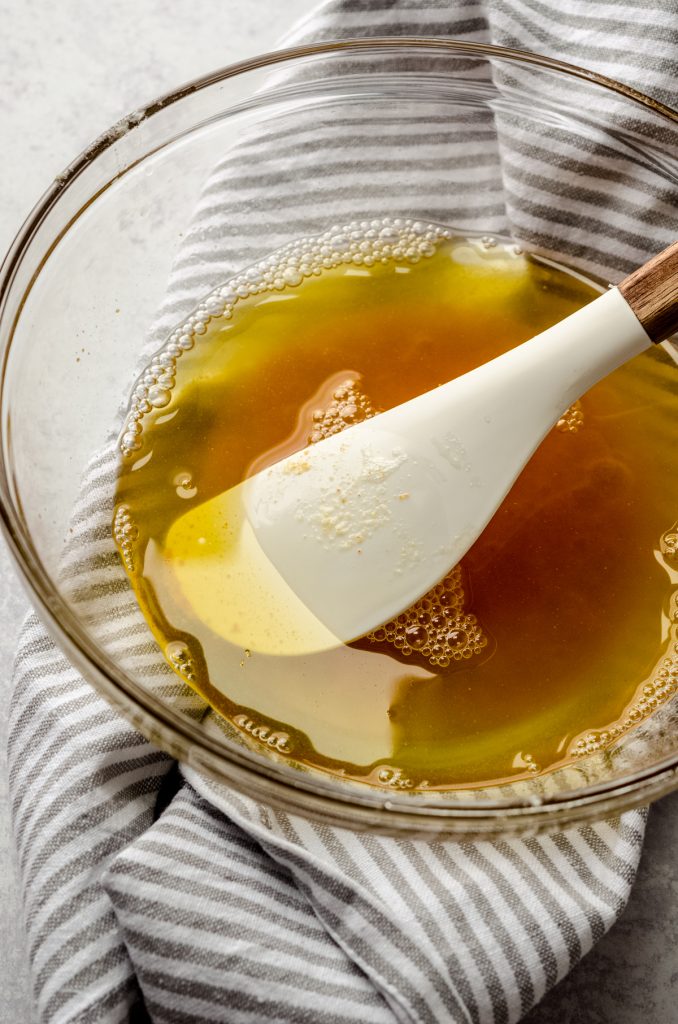 A bowl of brown butter with a spatula in it.