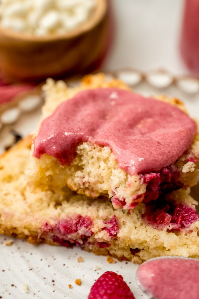 A raspberry white chocolate chip scone cut in half and spread with raspberry curd.