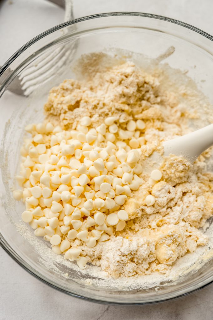Scone dough coming together in a bowl with a large spatula.