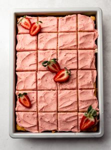 Aerial photo of strawberry sheet cake with frosting.