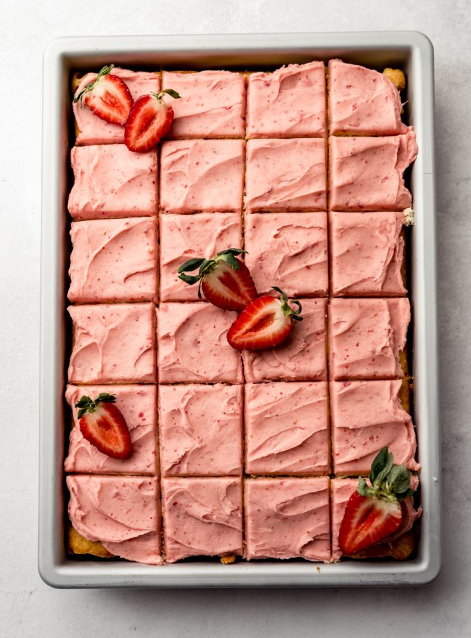 Aerial photo of strawberry sheet cake with frosting.