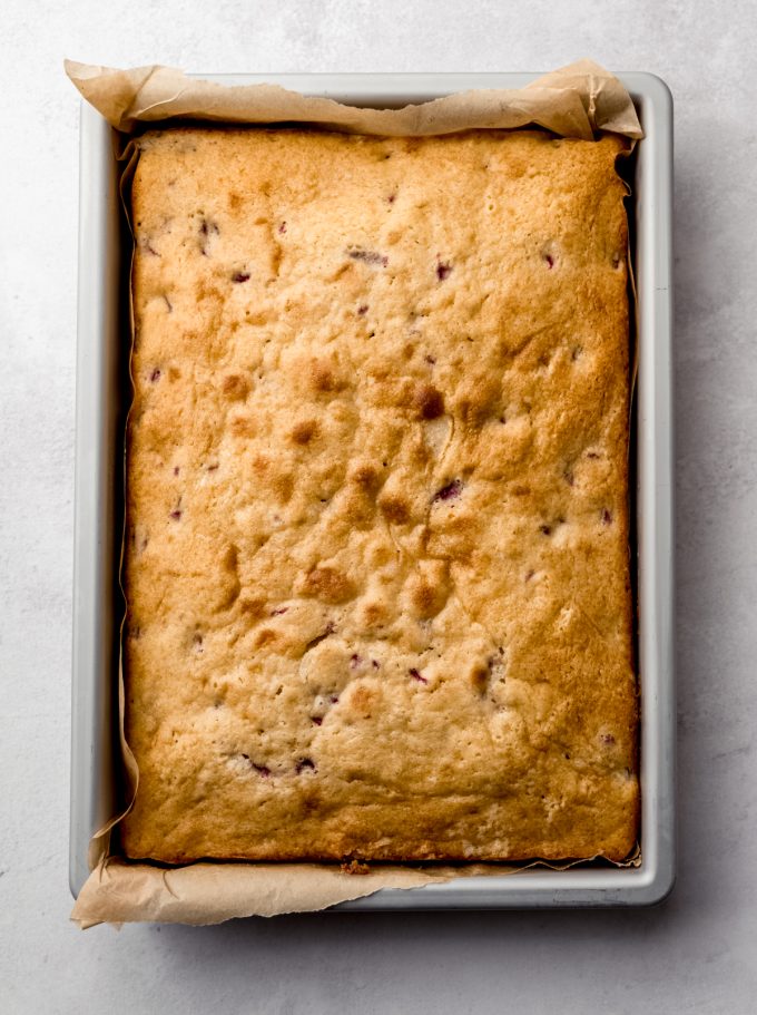 Aerial photo of strawberry sheet cake in a pan before frosting.