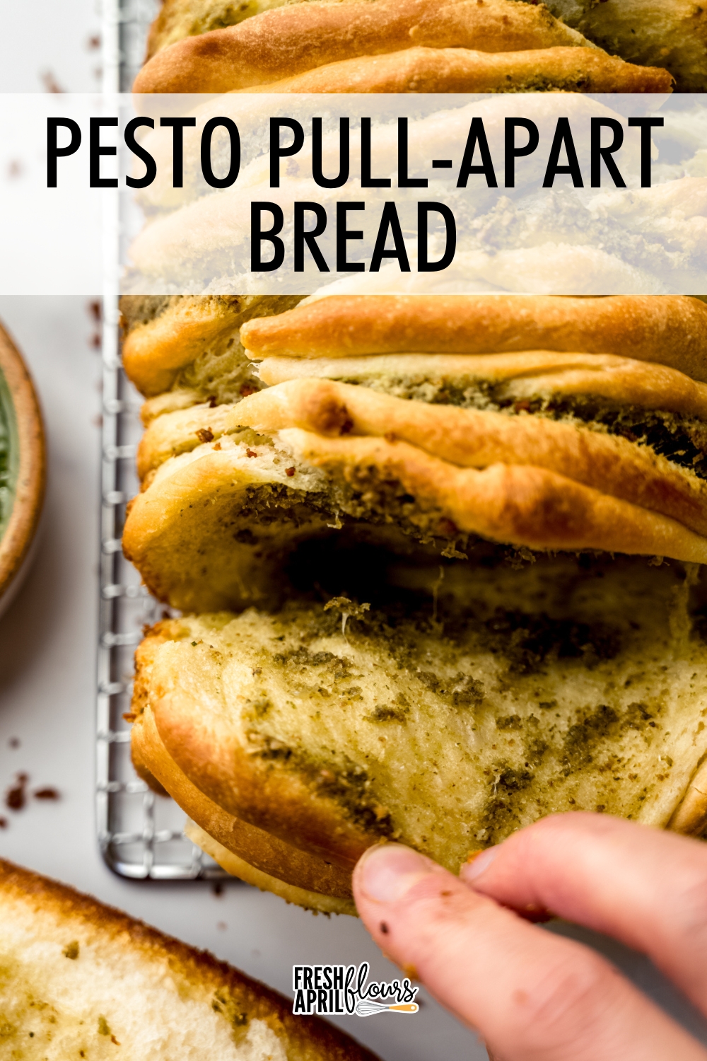 This pesto pull-apart bread is an herby, zesty bread made with homemade pesto layered between soft folds of enriched yeast bread. via @frshaprilflours