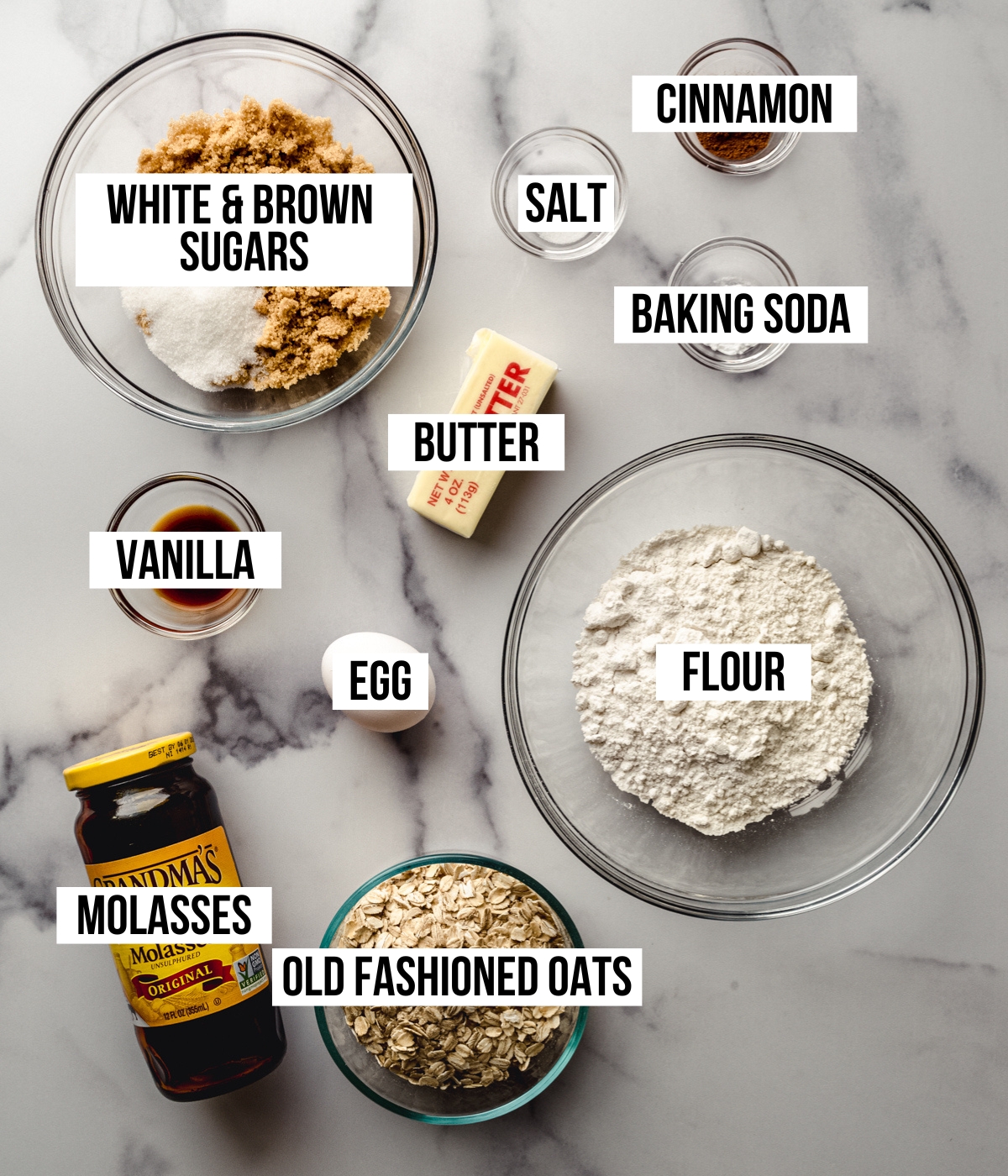 Aerial photo of ingredients to make chewy oatmeal cookies with text overlay labeling each ingredient.