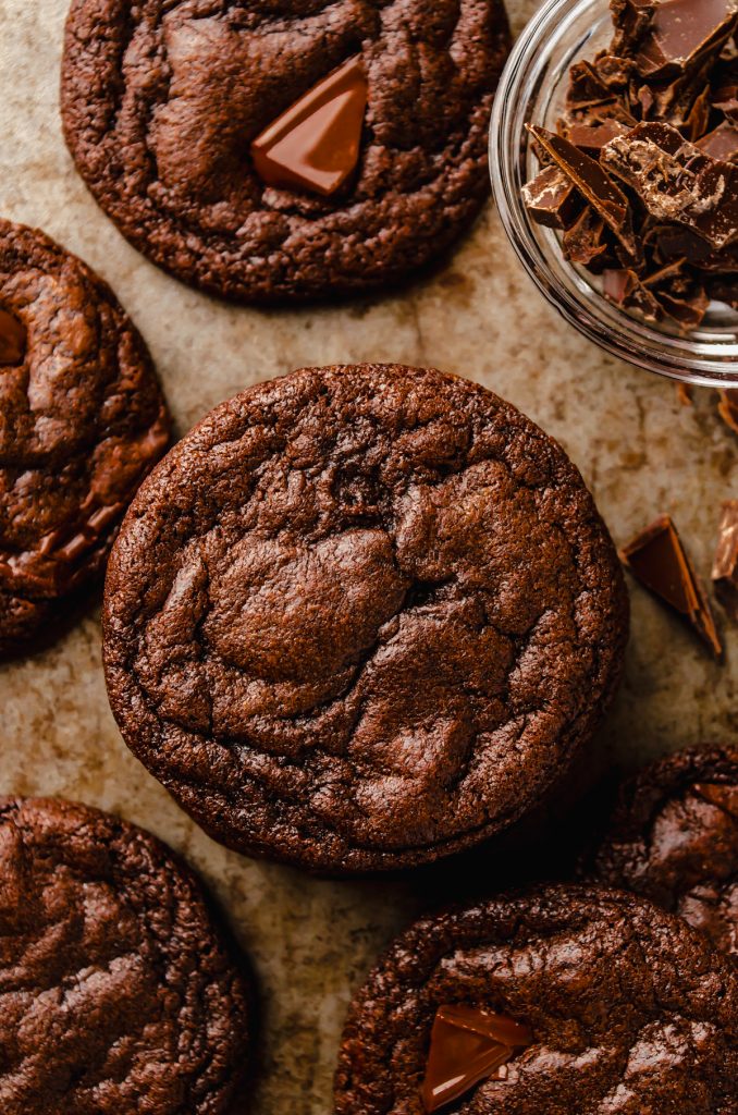 Aerial photo of a stack of dark chocolate cookies on a surface.