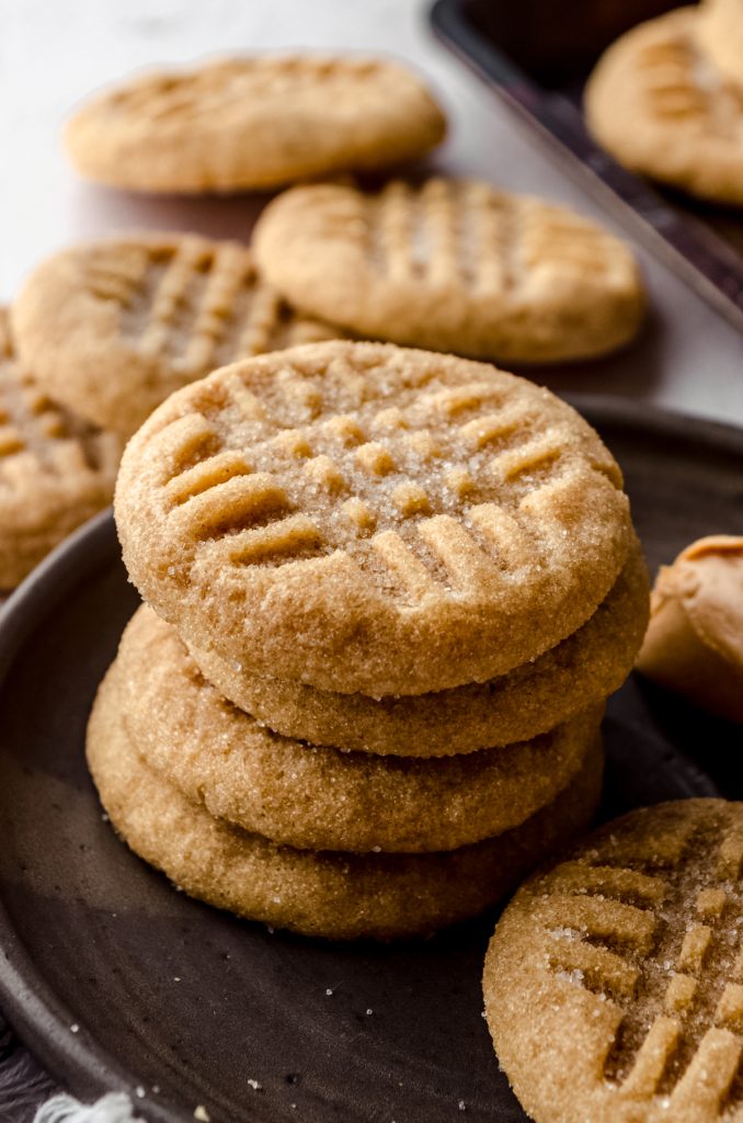 A stack of classic peanut butter cookies on a plate.