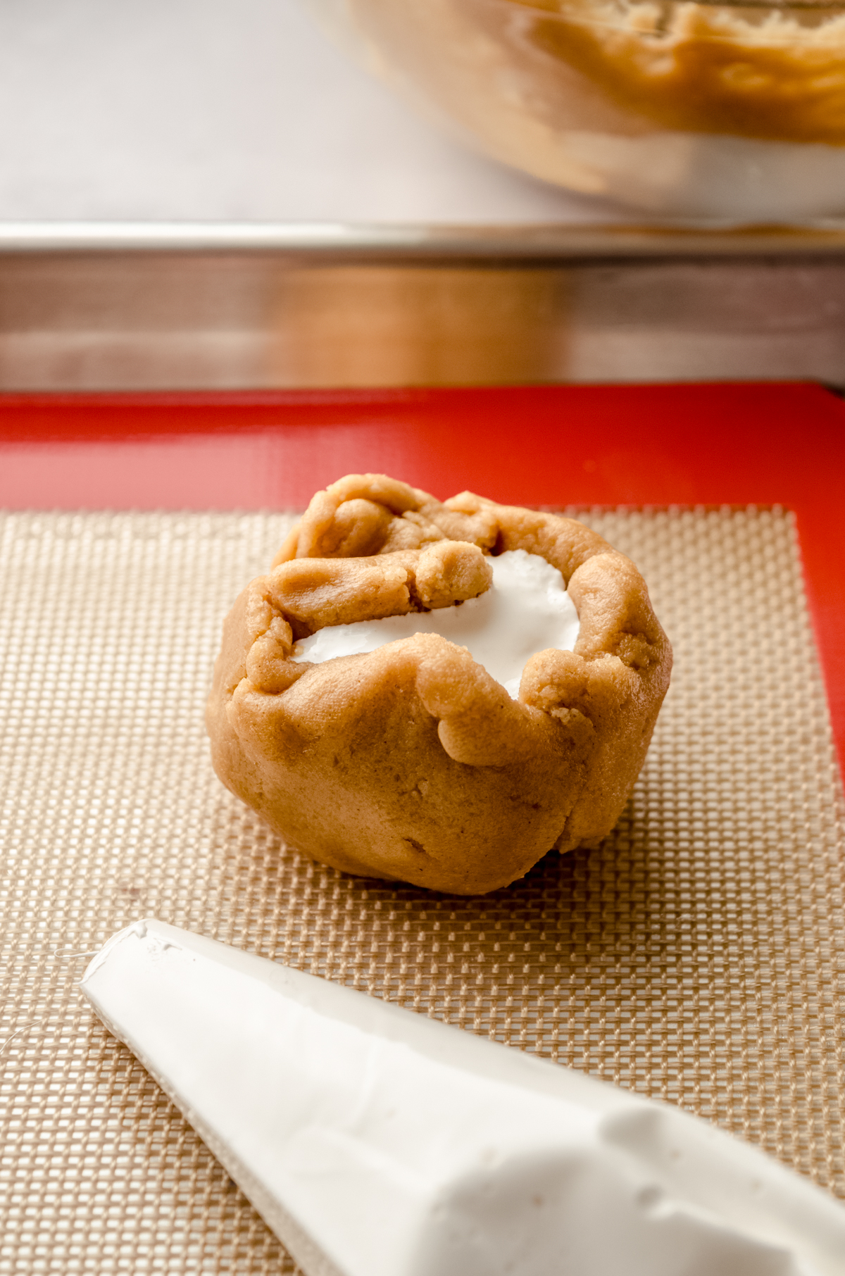 A fluffernutter cookie dough ball on a baking sheet.