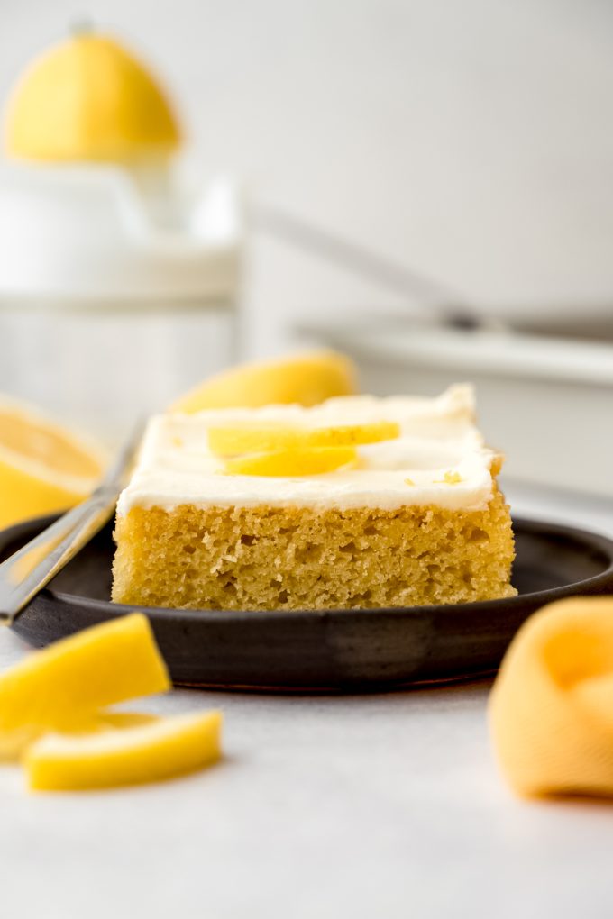A slice of lemon sheet cake on a plate.