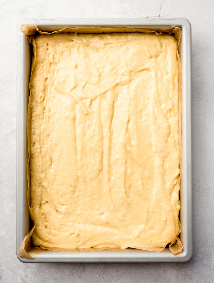 Aerial photo of lemon sheet cake batter in a baking sheet.