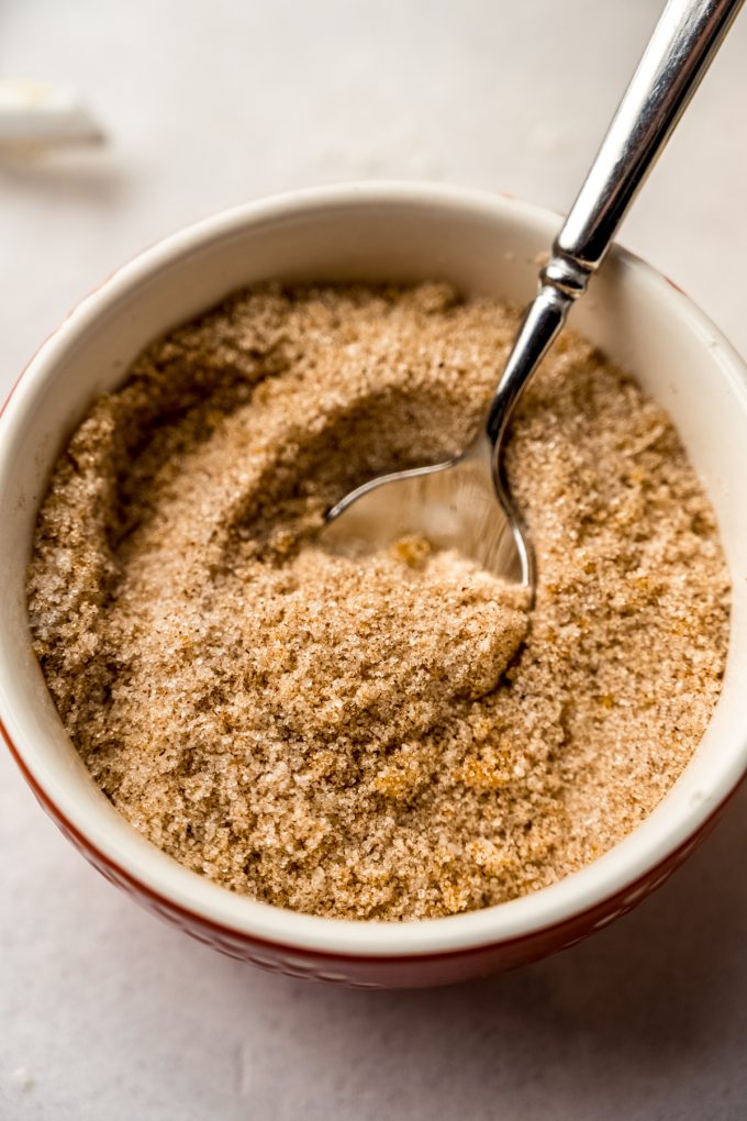 A bowl of spiced filling for orange rolls.