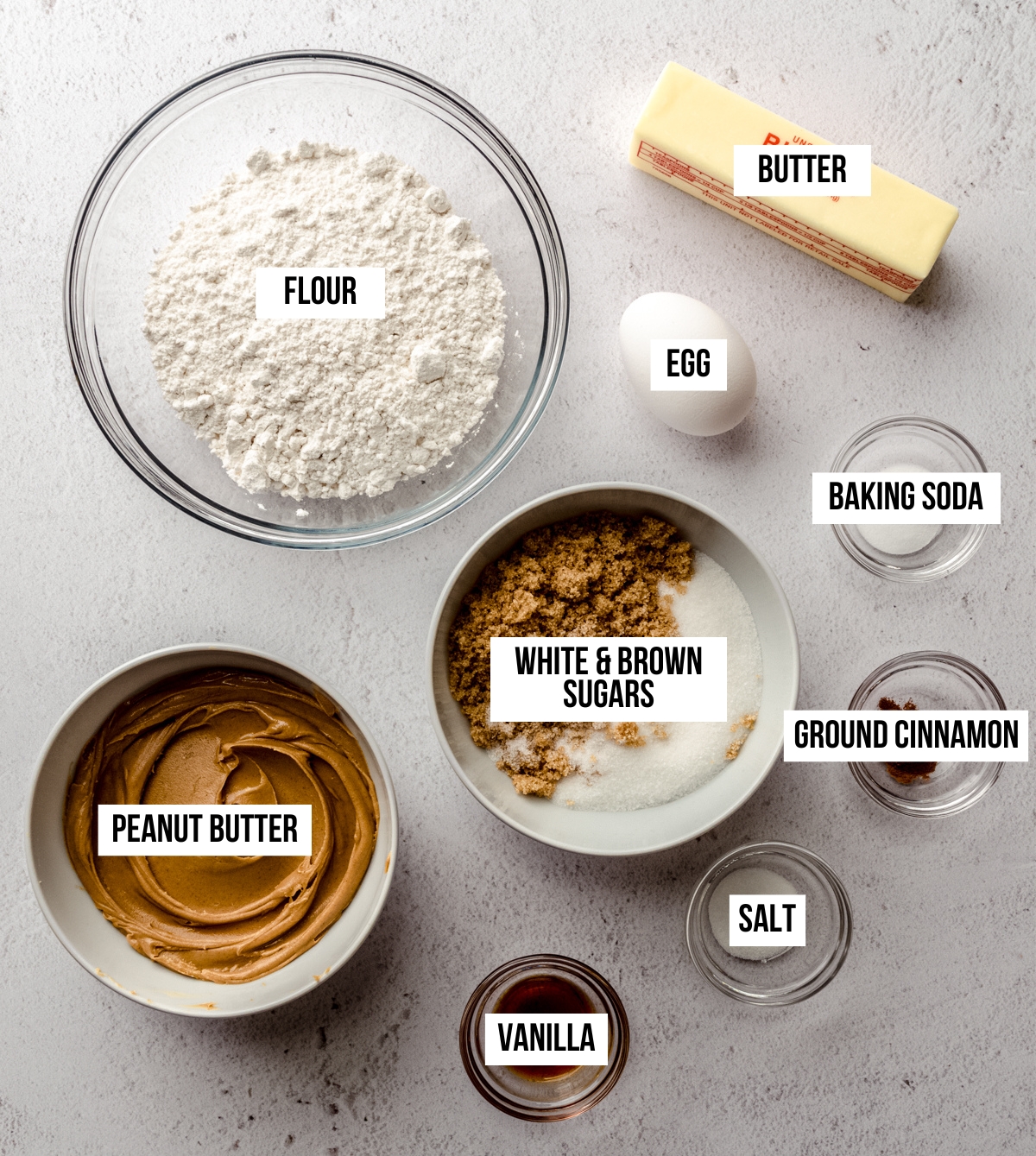 Aerial photo of ingredients to make classic peanut butter cookies with text overlay labeling each ingredient.