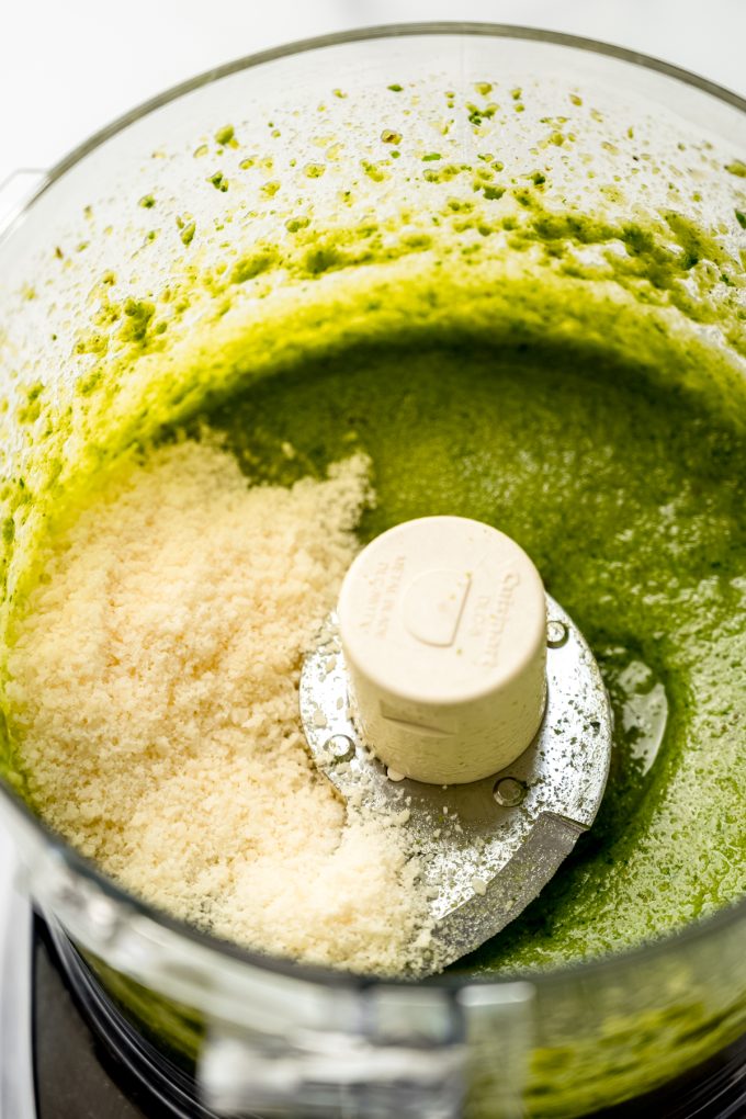 Homemade pesto being made in a food processor.