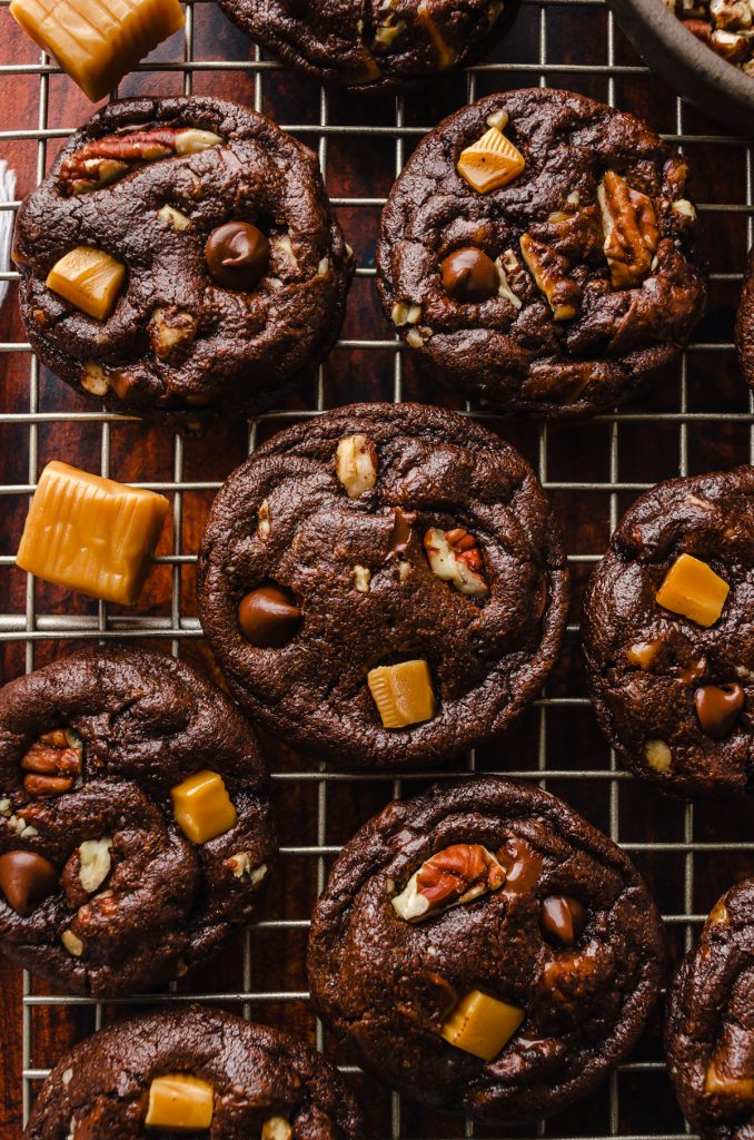 Aerial photo of chocolate turtle cookies on cooling rack.