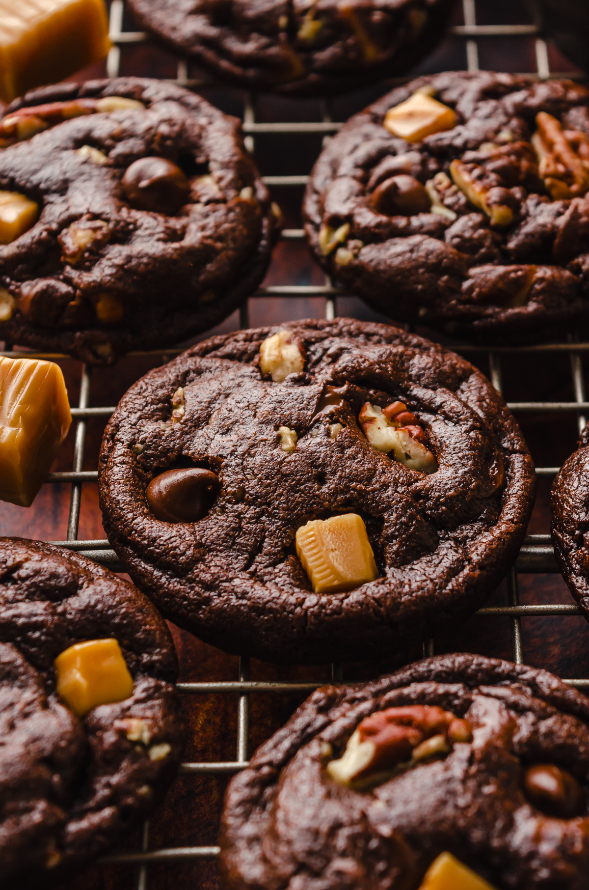 Chocolate turtle cookies on cooling rack.