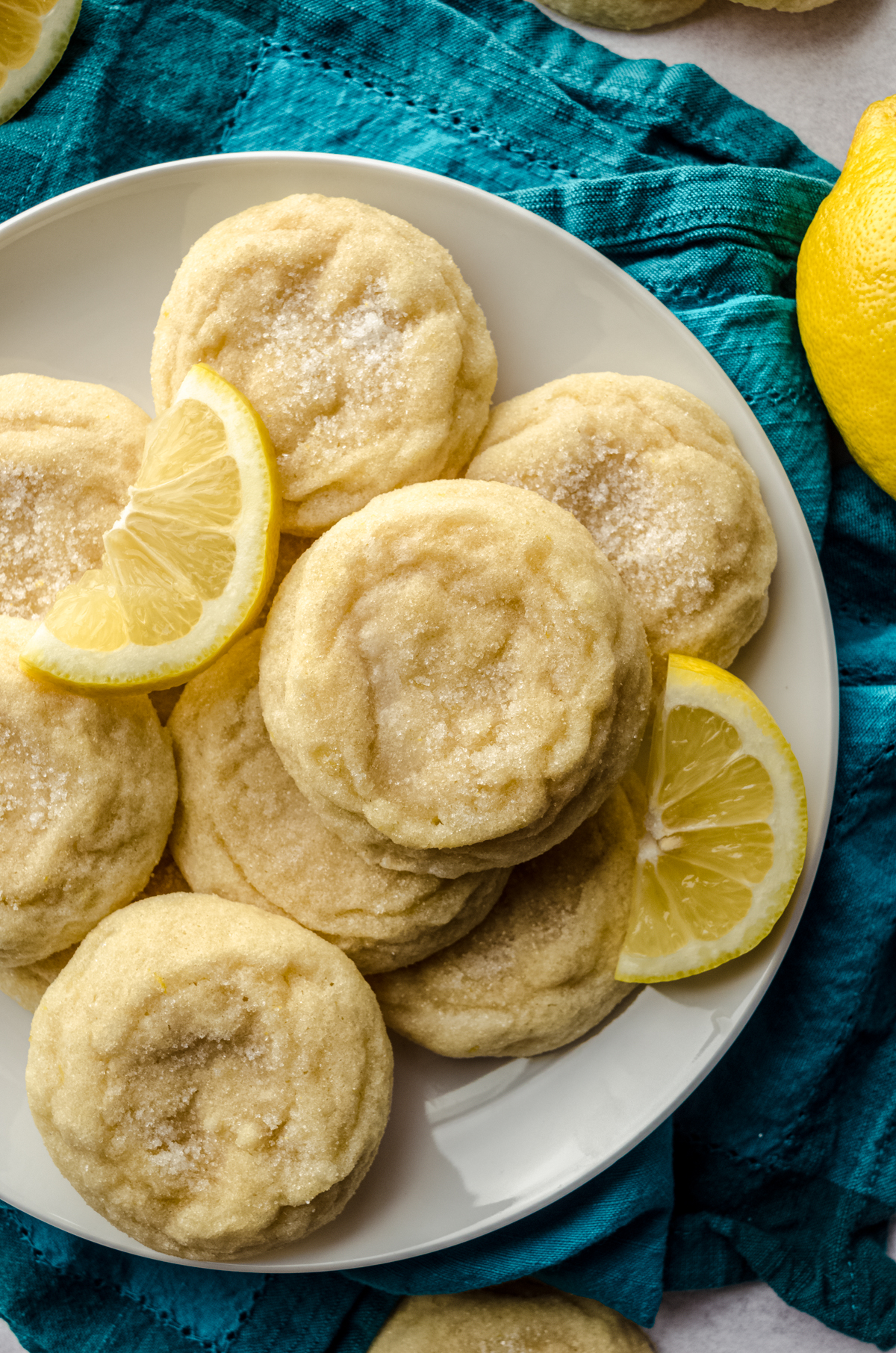 Aerial photo of lemon sugar cookies on a plate with lemon slices