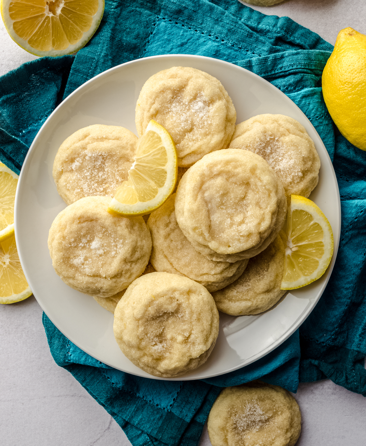 Aerial photo of lemon sugar cookies on a plate with lemon slices