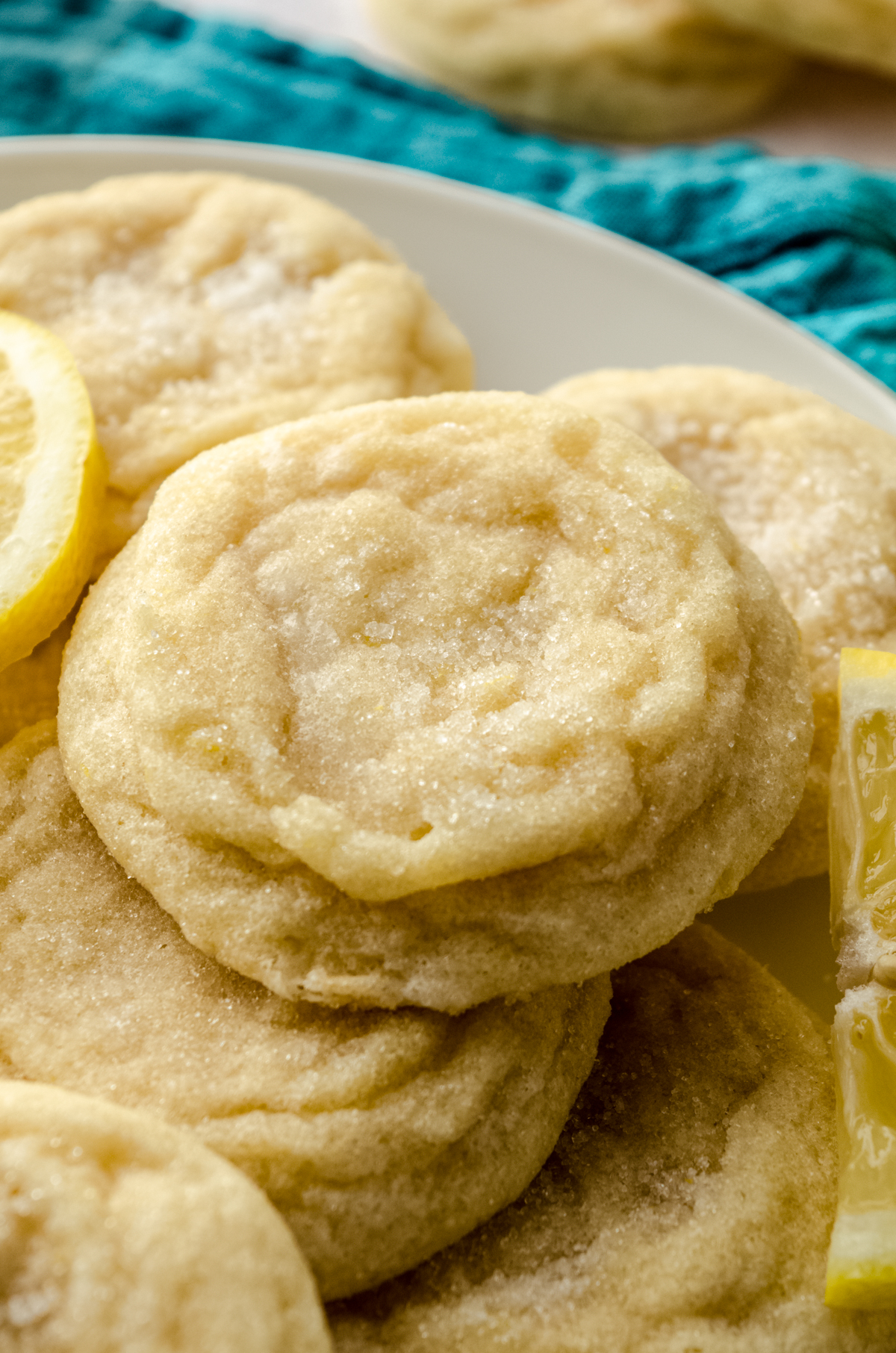 A plate of lemon sugar cookies with lemon slices.